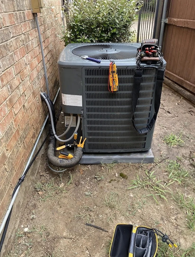 Outdoor air-conditioning condenser undergoing commissioning checks after installation in Grapevine, TX.