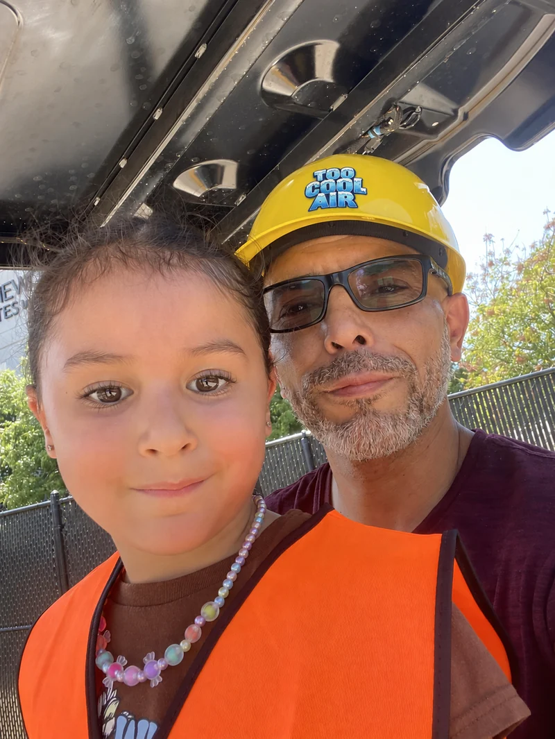 Too Cool Air founder Sergio Villarreal with his daughter at a community event