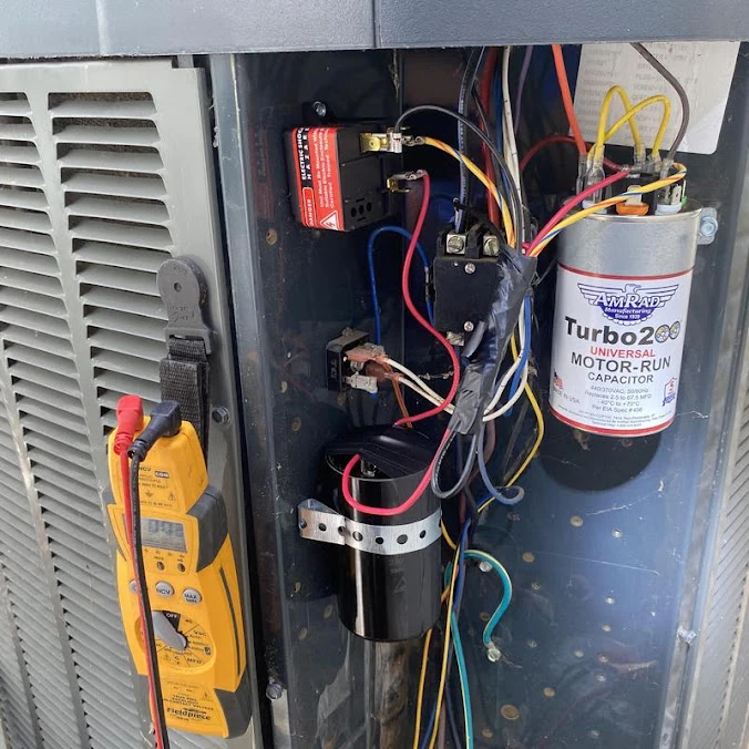 Too Cool Air technician testing an outdoor AC condenser electrical system