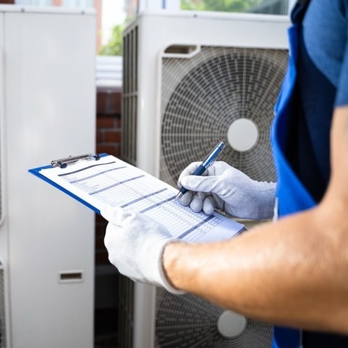 An HVAC Contractor Checks out HVAC System.